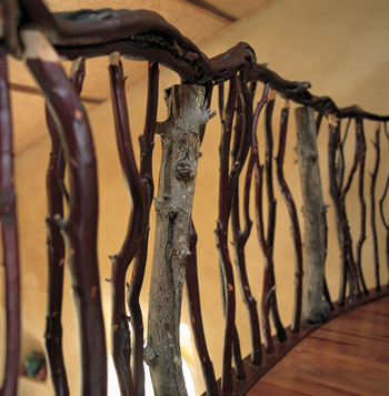 Artisans who worked on the house handcrafted this handrail from manzanita and apple boughs found on the site.